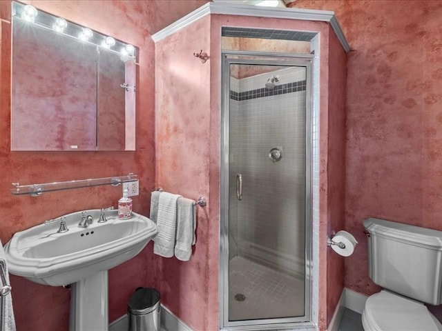 bathroom with a shower with door and toilet