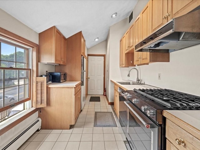 kitchen with lofted ceiling, light tile patterned floors, sink, a baseboard heating unit, and stainless steel appliances