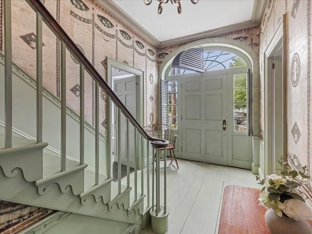 foyer entrance featuring crown molding