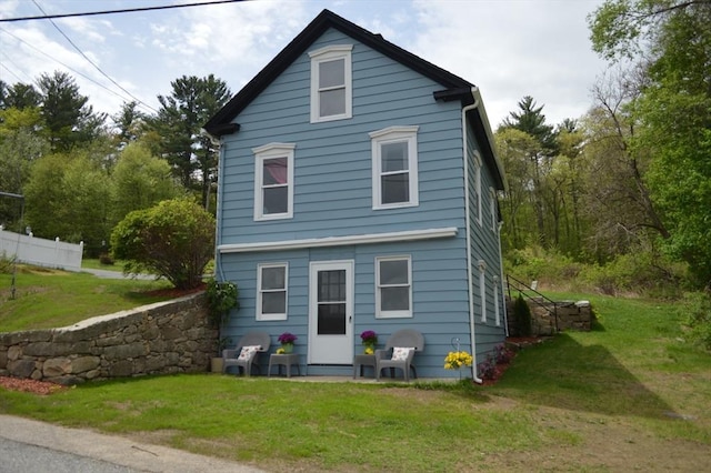 back of house featuring a lawn