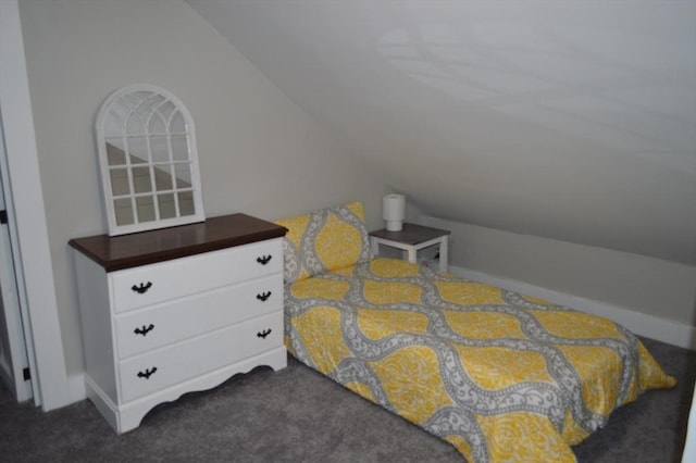 bedroom featuring vaulted ceiling and dark carpet