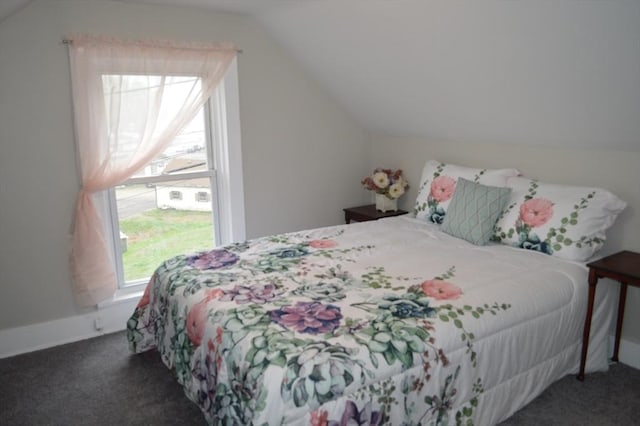 carpeted bedroom with lofted ceiling