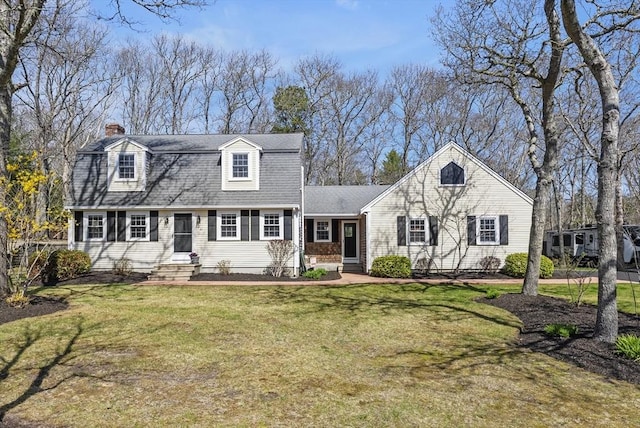 view of front of property featuring a chimney, a front yard, and entry steps