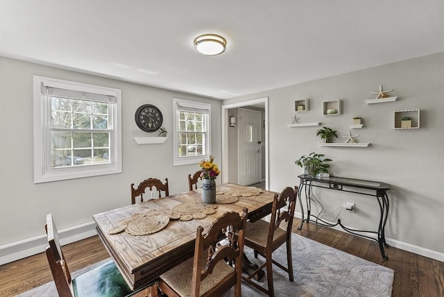 dining space featuring baseboards, plenty of natural light, and wood finished floors
