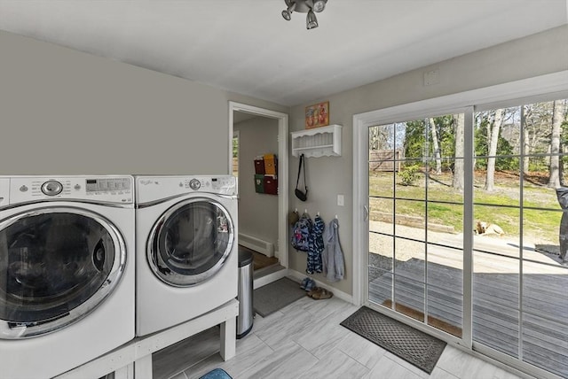 laundry room with baseboards, laundry area, and independent washer and dryer