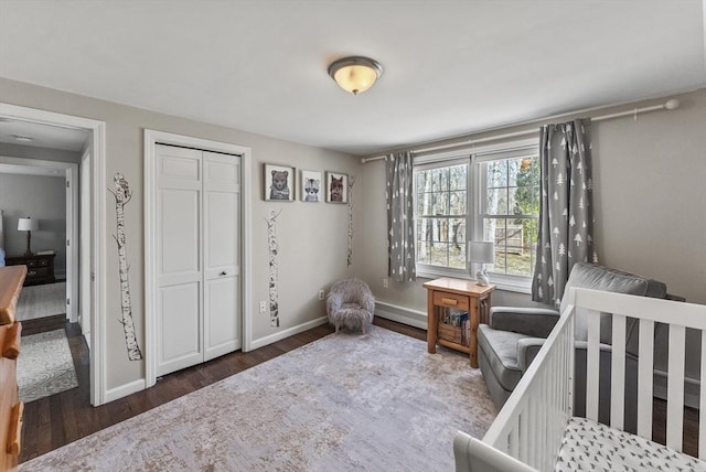 bedroom featuring baseboards, a closet, and wood finished floors