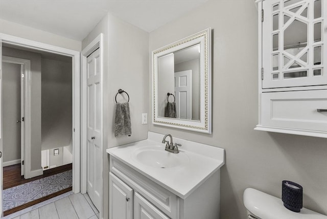 half bathroom with vanity and toilet