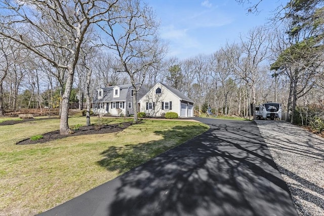 exterior space with a front lawn and aphalt driveway