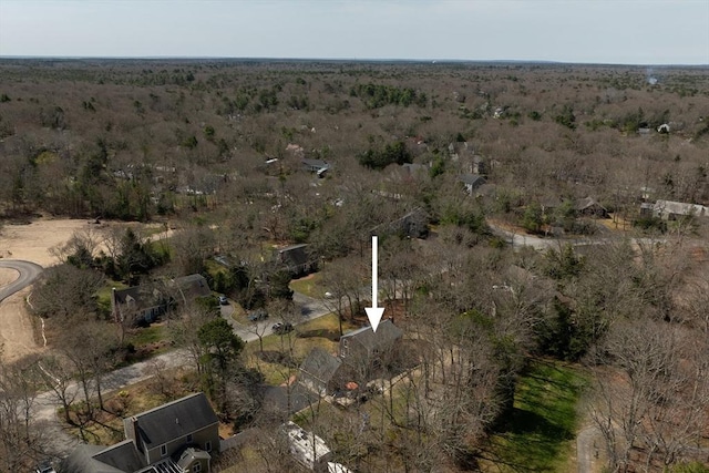 bird's eye view with a wooded view
