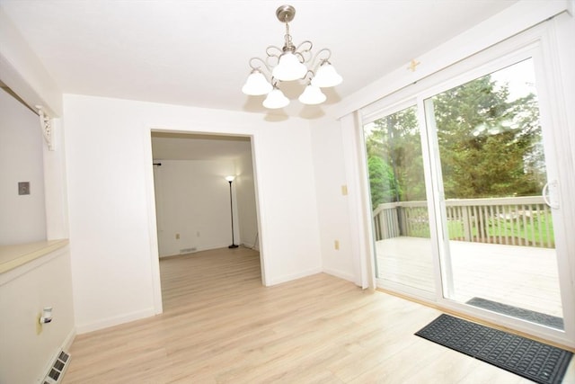 unfurnished dining area featuring a chandelier, light wood finished floors, and baseboards