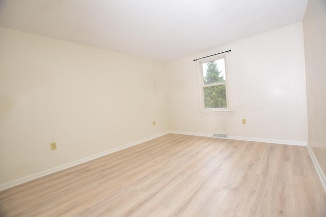 unfurnished room featuring light wood-style flooring and baseboards