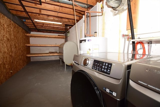 garage featuring independent washer and dryer, water heater, and oil tank