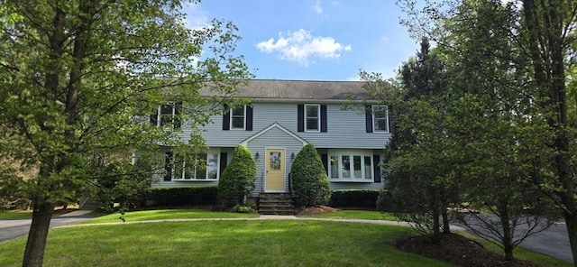 colonial-style house with a front yard