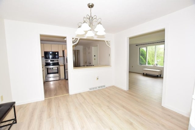 unfurnished dining area with a chandelier, light wood-style floors, and baseboards