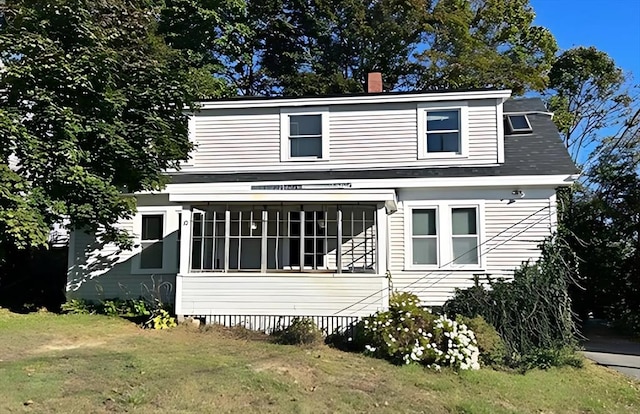 view of front of home with a front lawn and a chimney