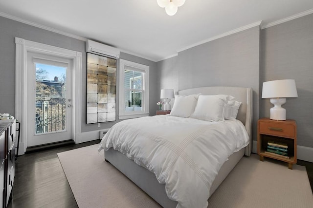 bedroom featuring ornamental molding, an AC wall unit, wood finished floors, and access to exterior