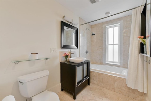 bathroom with visible vents, tile patterned floors, tiled shower / bath, vanity, and toilet