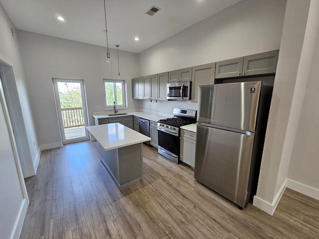 kitchen featuring visible vents, gray cabinets, appliances with stainless steel finishes, and light wood-type flooring