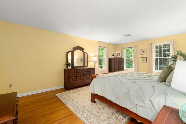 bedroom featuring wood finished floors and baseboards