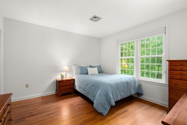 bedroom featuring wood finished floors and baseboards