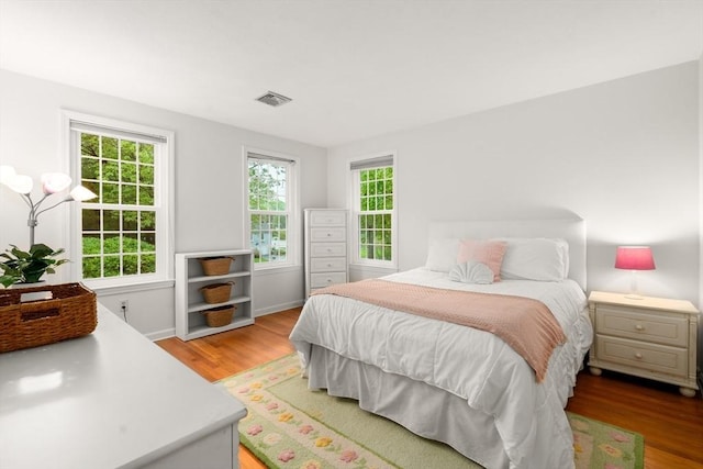 bedroom featuring light wood-style floors and baseboards