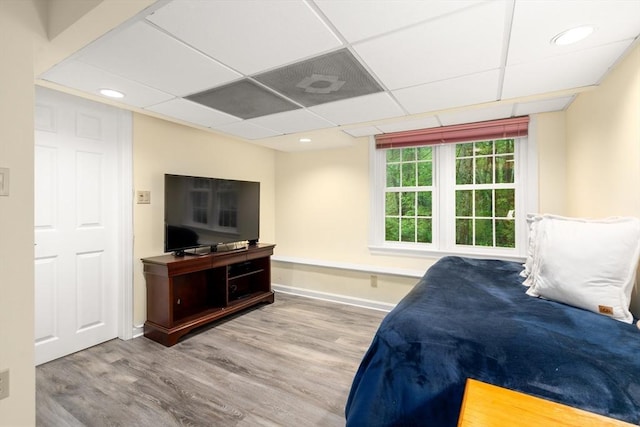 bedroom with wood finished floors, baseboards, and recessed lighting