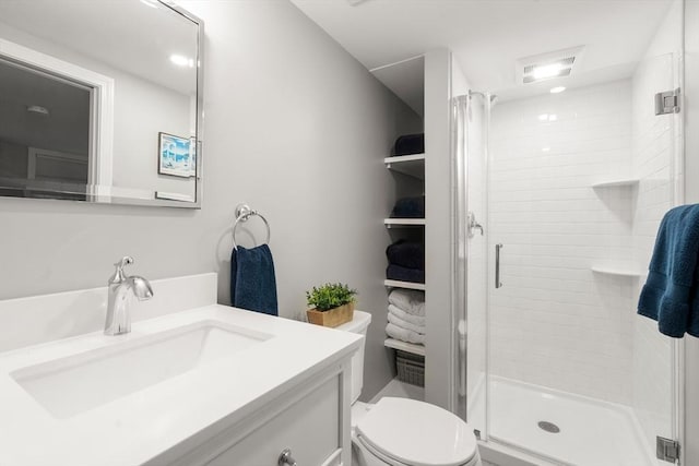 full bathroom with toilet, a shower stall, and vanity
