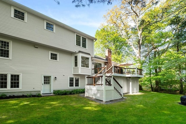 back of house with stairway, a yard, and a wooden deck