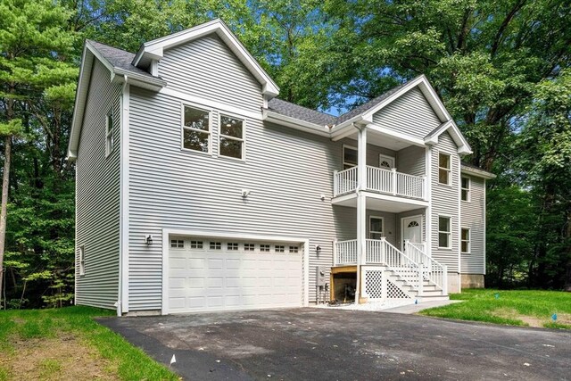 view of front of property with a garage and a balcony