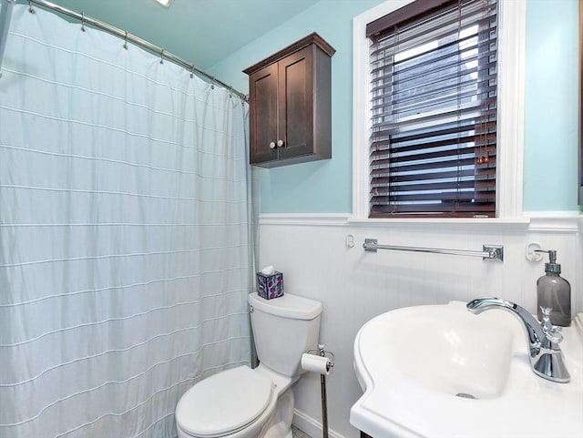 110 Reed St, Cambridge, MA 02140 - bathroom with a sink, toilet, wainscoting, and a shower with shower curtain