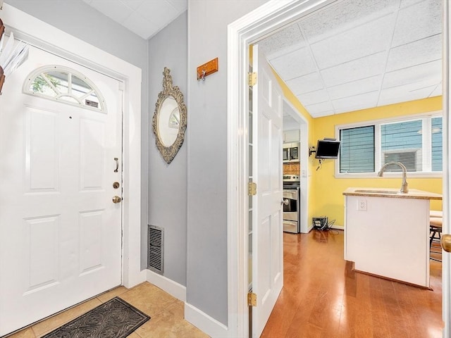 110 Reed St, Cambridge, MA 02140 - entrance foyer with baseboards, a drop ceiling, and wood finished floors