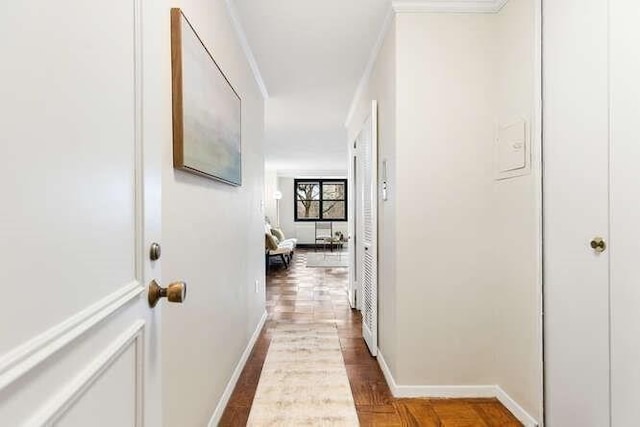 corridor with baseboards and ornamental molding