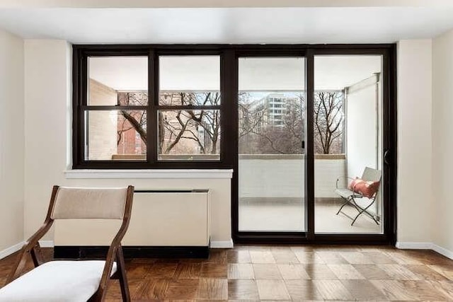 doorway to outside with baseboards