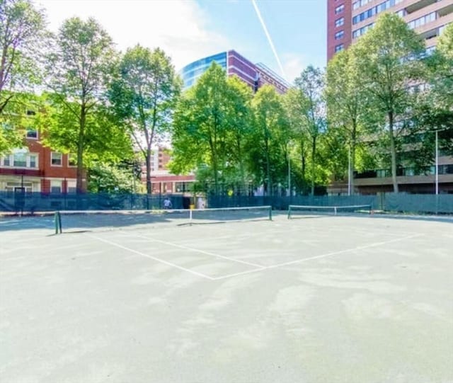 view of tennis court featuring fence