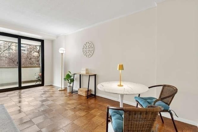 sitting room featuring a wall of windows and baseboards