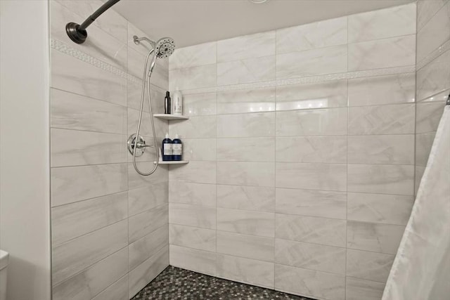 full bath featuring a tile shower