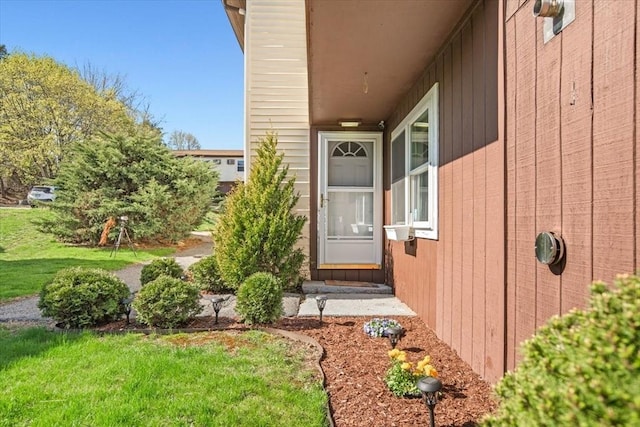 entrance to property with a lawn