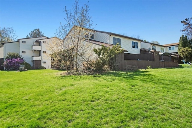 rear view of house featuring a lawn