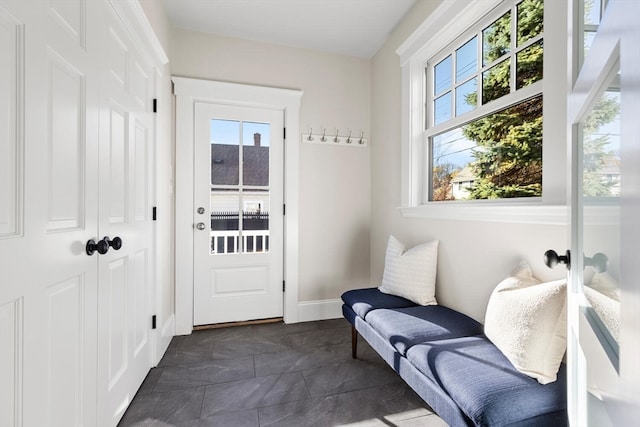 doorway with dark tile patterned floors