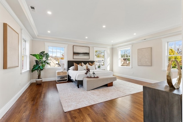 bedroom featuring dark hardwood / wood-style flooring, multiple windows, and ornamental molding