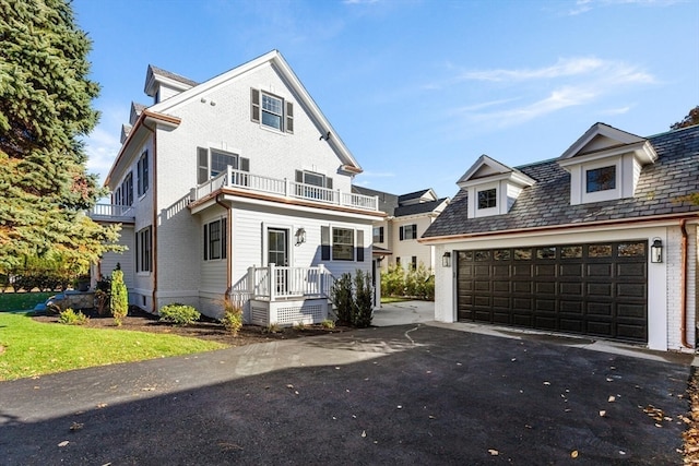 view of front of home with a garage and a balcony