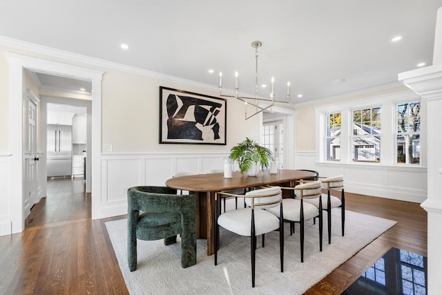 dining room featuring a notable chandelier, dark hardwood / wood-style floors, and crown molding