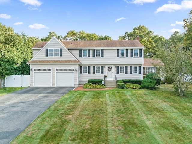 view of front facade with a garage and a front yard