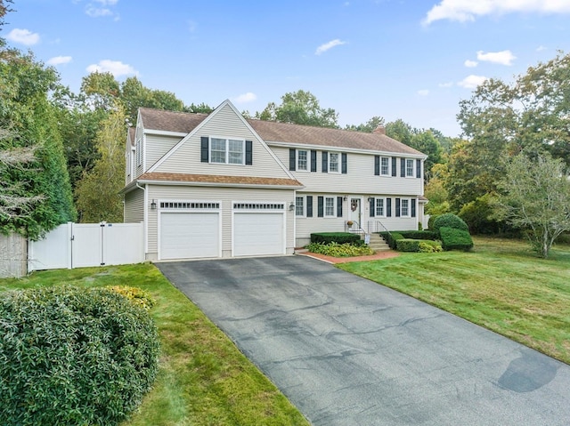 view of front of property with a front yard and a garage