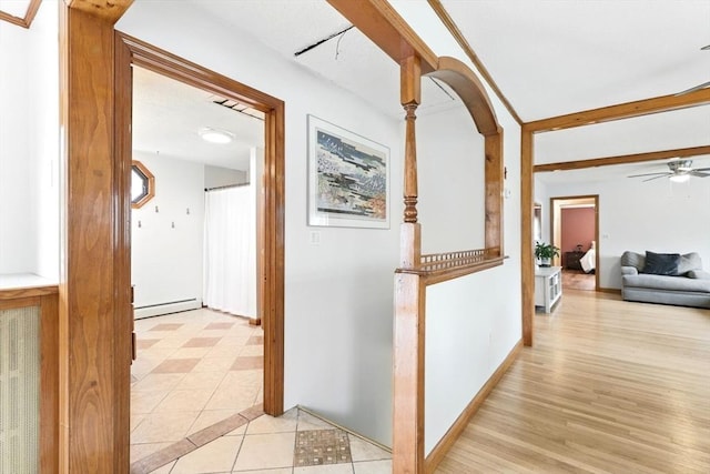 hall with light tile patterned floors and a baseboard radiator