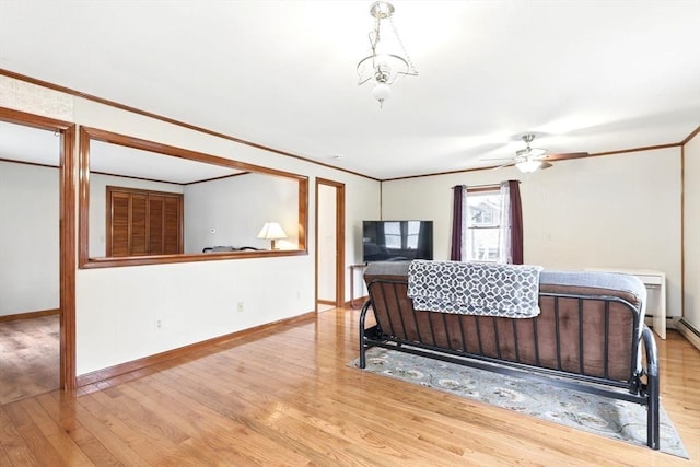 bedroom with baseboards, ornamental molding, and wood finished floors