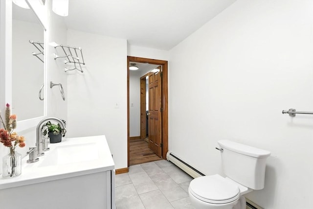 bathroom with vanity, toilet, baseboards, a baseboard radiator, and a baseboard heating unit