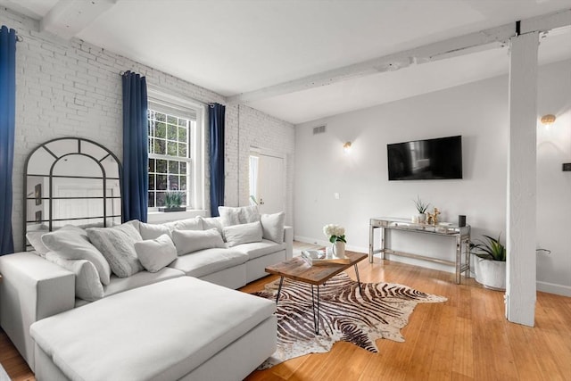 7 S Stone Mill Dr Unit 403, Dedham, MA 02026 - living area featuring beam ceiling, brick wall, light wood-style floors, and baseboards