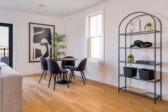 dining area featuring light hardwood / wood-style flooring and a healthy amount of sunlight