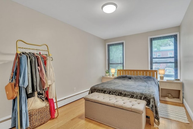 32 Juniper St Unit 91, Brookline, MA 02445 - bedroom featuring a baseboard radiator and wood finished floors